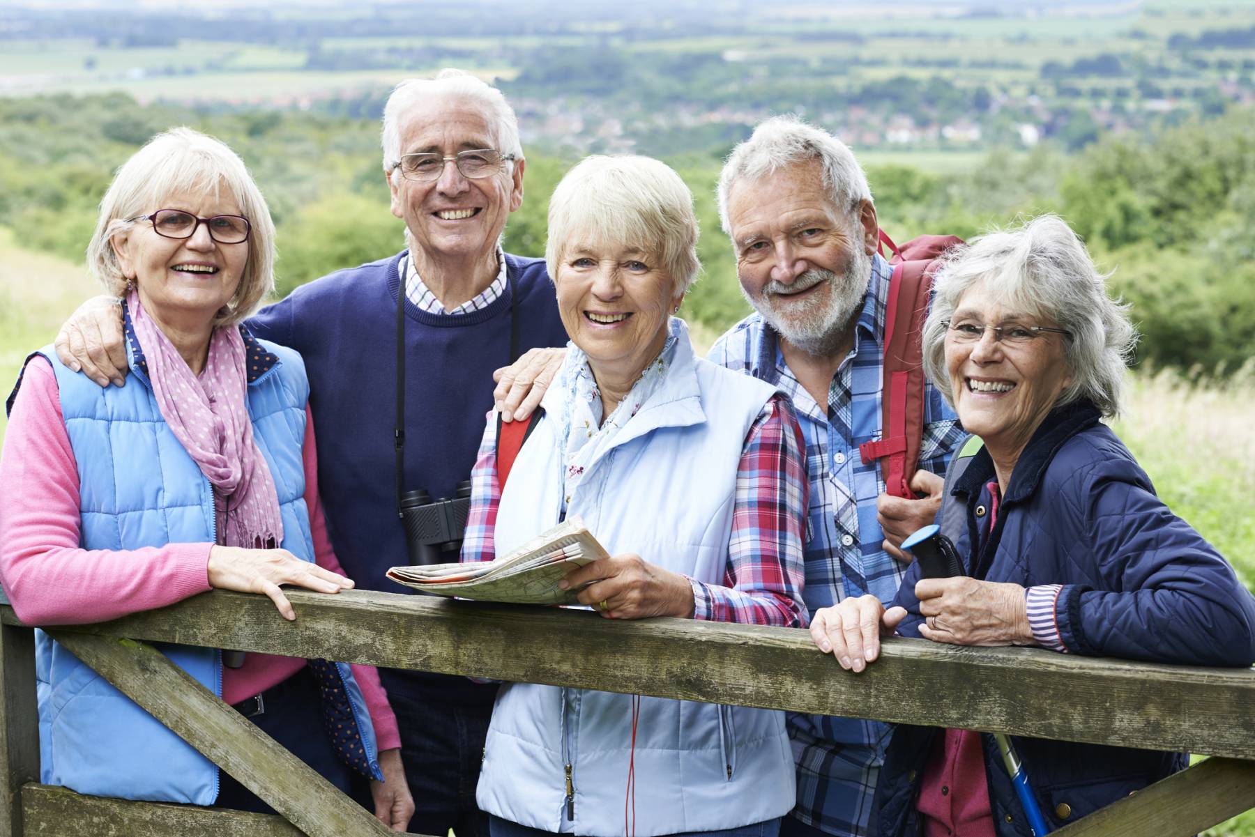 Group Of Senior Friends Hiking In Countryside