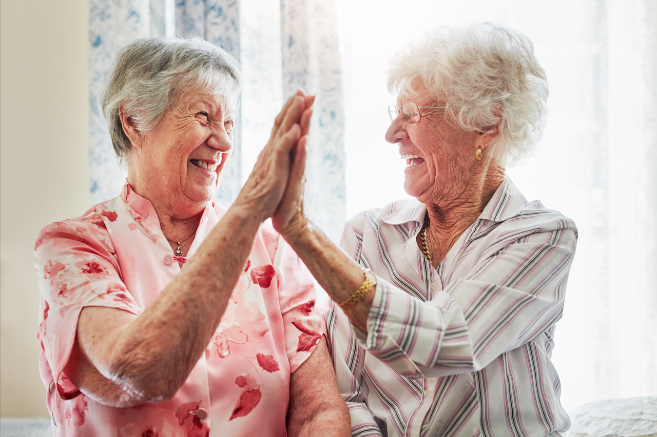 Two Senior Women Giving High Fives